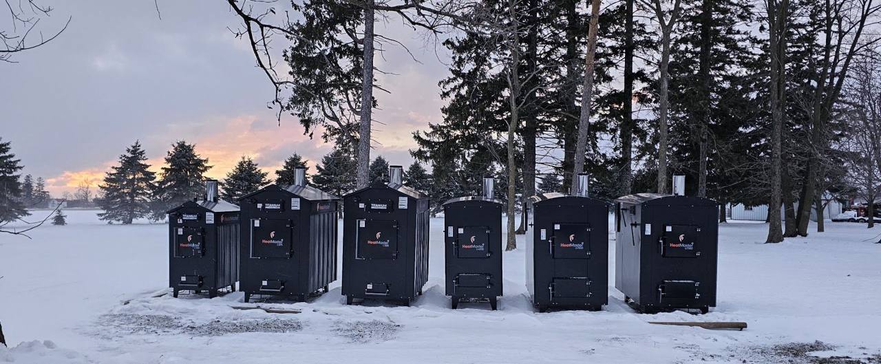 Stainless steel HeatMaster outdoor boilers sitting in the snow