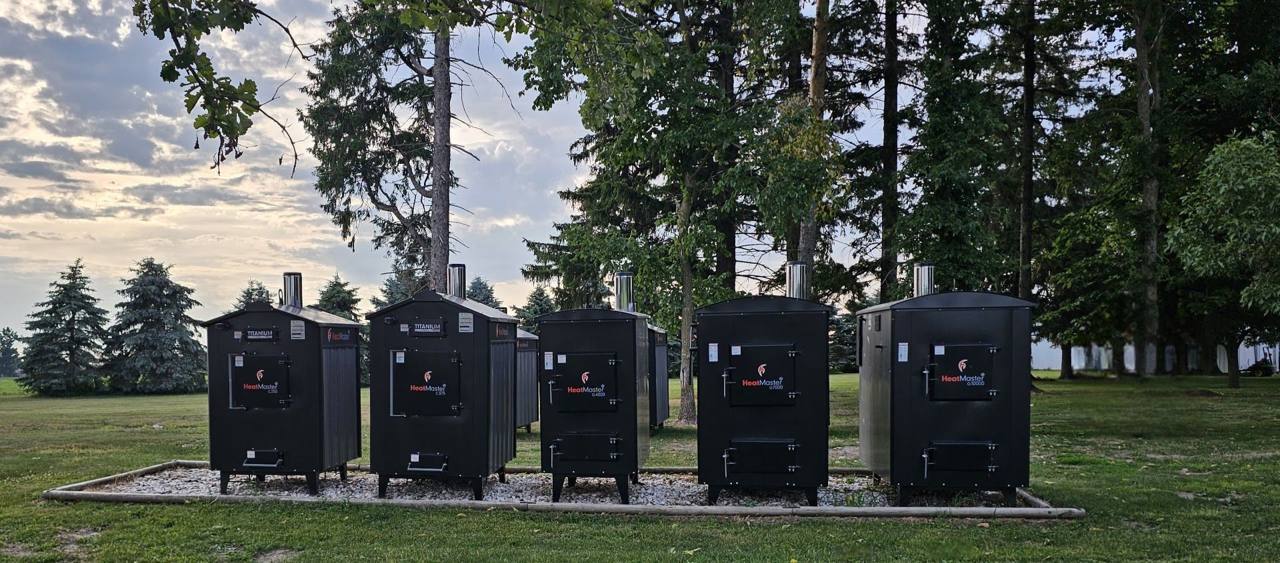 A row of new HeatMaster outdoor boilers on the lot at Pineview Woodstoves