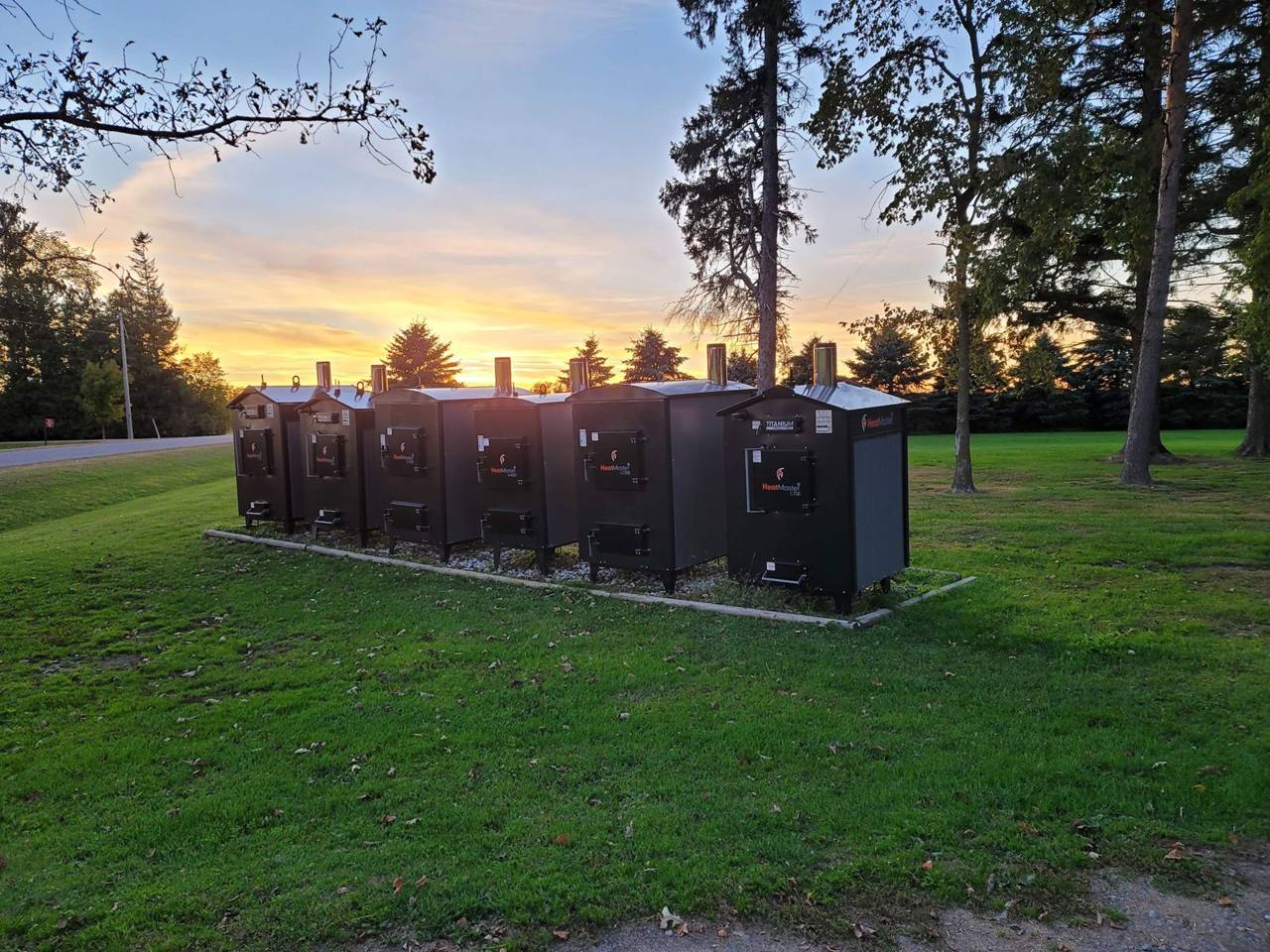 HeatMaster outdoor boilers in several sizes lined up at sunset