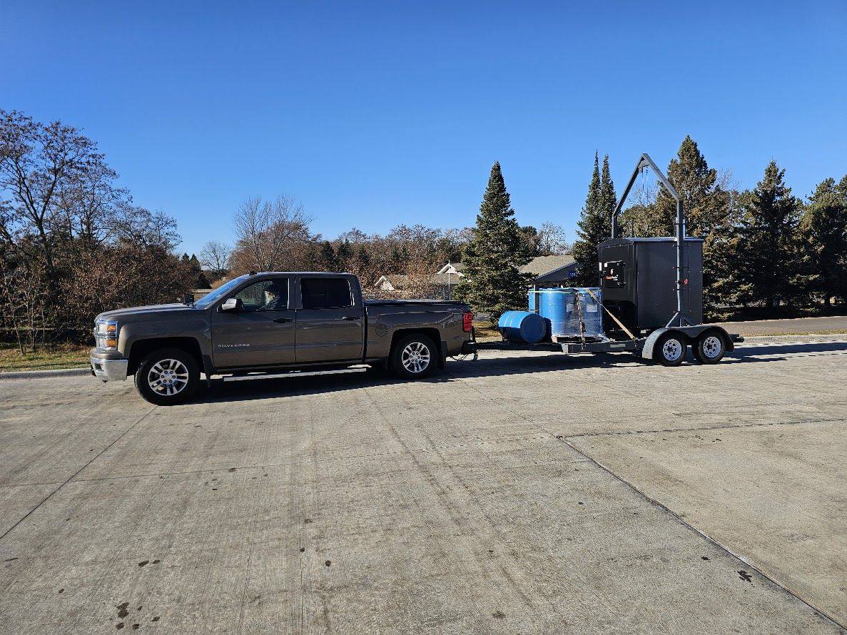 Our hoop trailer hauling a new HeatMaster and antifreeze barrels