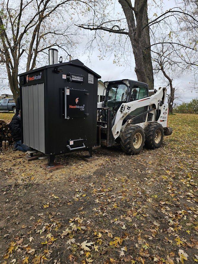 Setting a new HeatMaster C250 with our skid steer